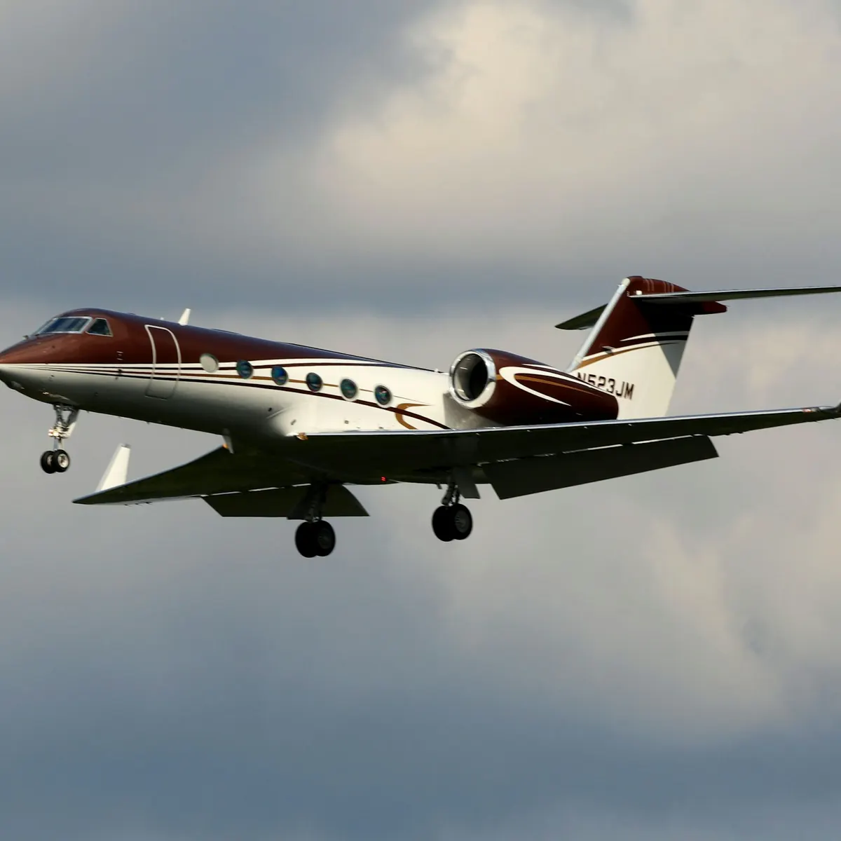 Light business jet in flight above the clouds
