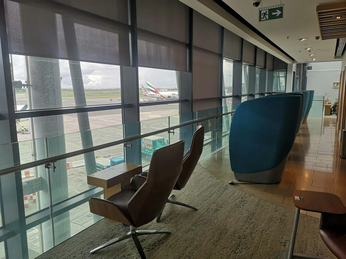 Private terminal lounge with armchairs and a view of the ramp