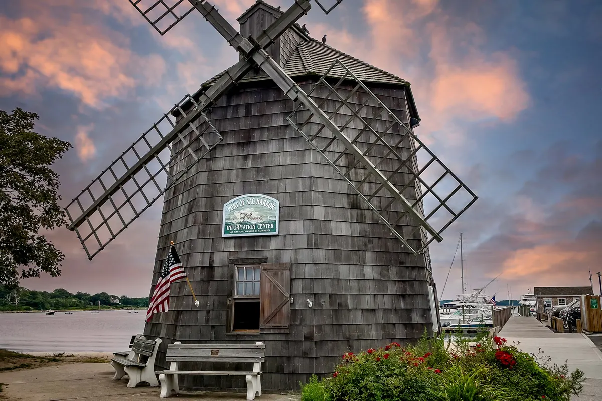 Historic windmill on a green lawn in the Hamptons